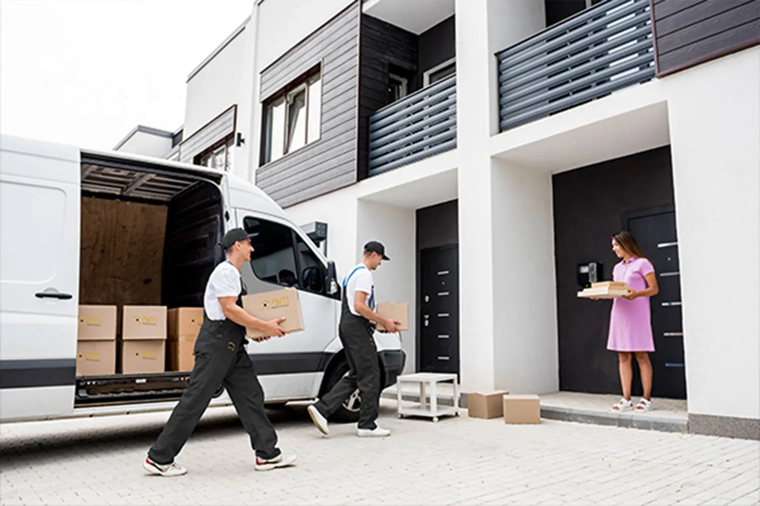 AKM movers loading a van outside a home